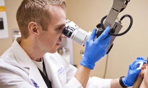 ENT doctor and nurse working with patient