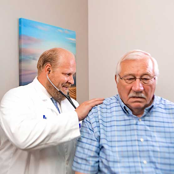 doctor checking patient's lungs