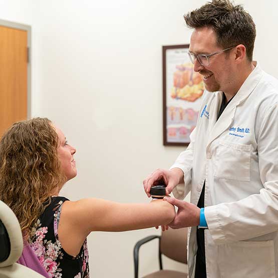 doctor looking at patients arm