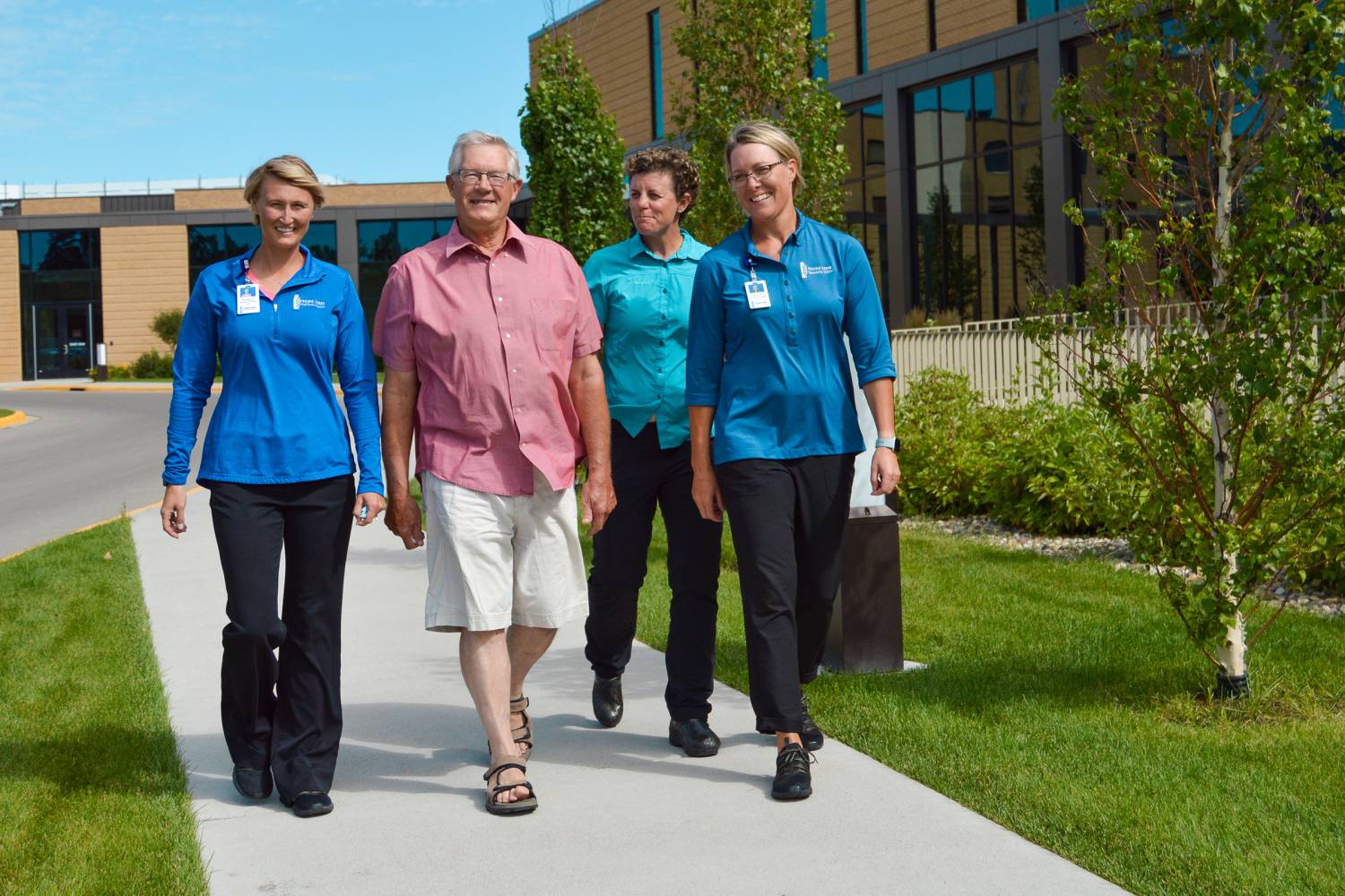 Kevin Walking with Rehab Team Members